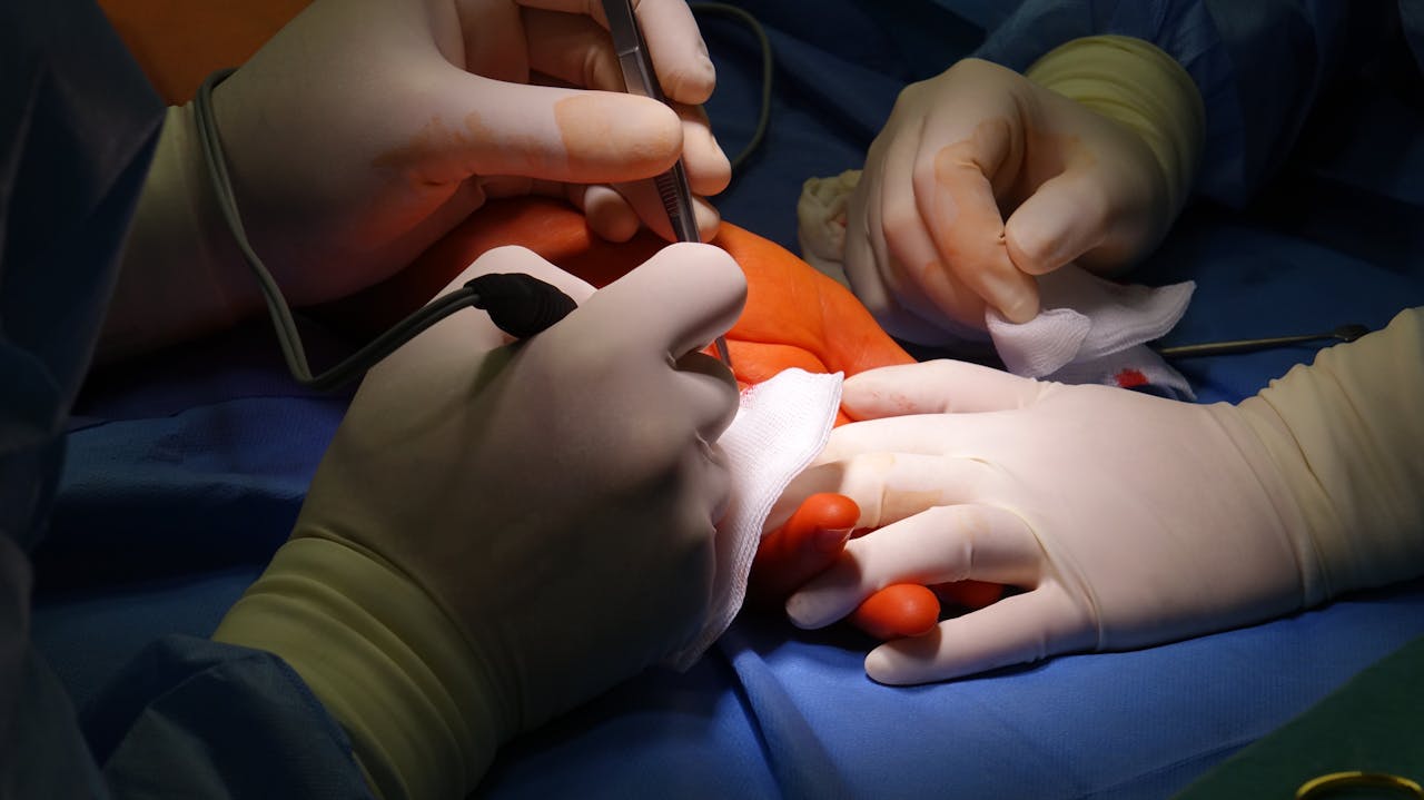 Surgeons performing delicate foot surgery in a sterile operating room environment.